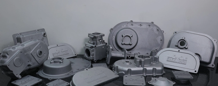 Various die-cast metal parts displayed on a table